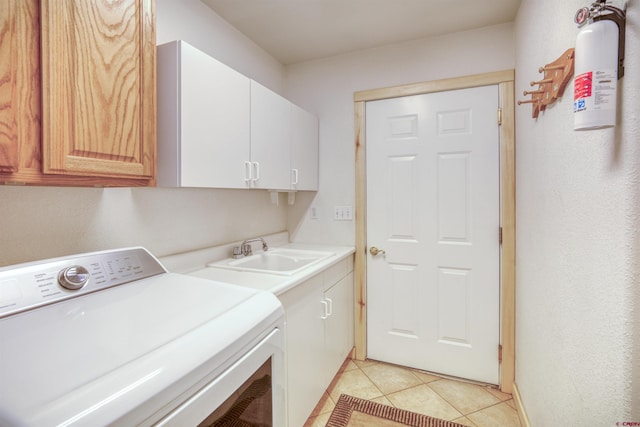 369 Beaver Cir, Pagosa Springs, CO 81147 - washroom featuring washer / clothes dryer, cabinet space, and light tile patterned flooring