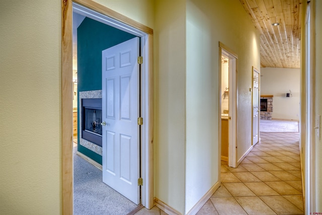 369 Beaver Cir, Pagosa Springs, CO 81147 - hall with light colored carpet, light tile patterned flooring, baseboards, and wood ceiling