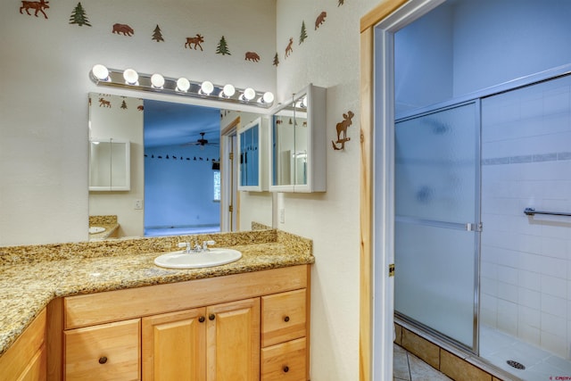 369 Beaver Cir, Pagosa Springs, CO 81147 - bathroom featuring ceiling fan, a shower stall, and vanity