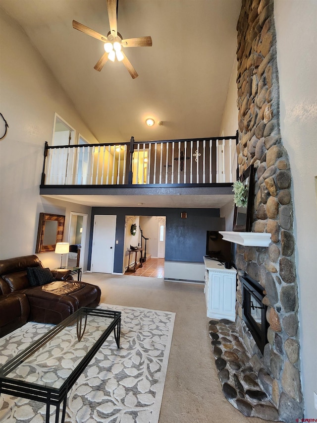 living area with ceiling fan, a fireplace, high vaulted ceiling, and carpet floors