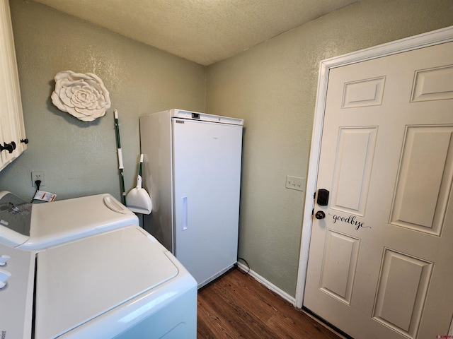 washroom with a textured ceiling, dark wood-style flooring, separate washer and dryer, cabinet space, and a textured wall