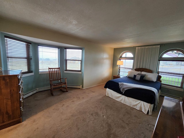 carpeted bedroom with a textured ceiling, baseboards, and a baseboard heating unit