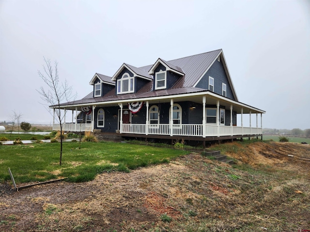 country-style home with covered porch, metal roof, and a front lawn