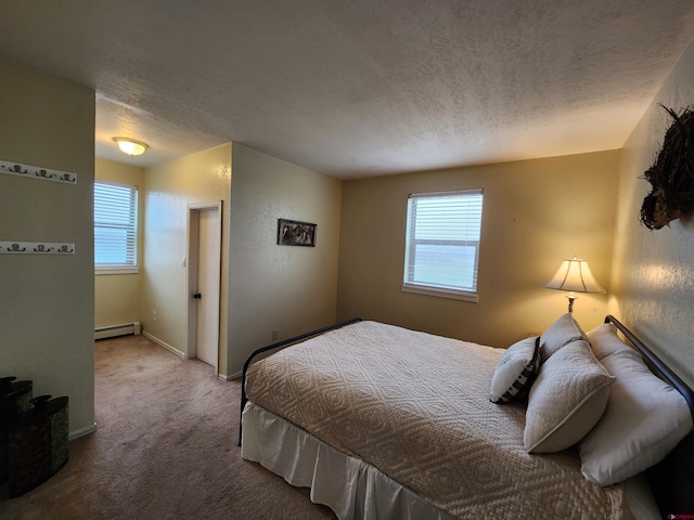carpeted bedroom featuring multiple windows, a textured ceiling, baseboards, and baseboard heating