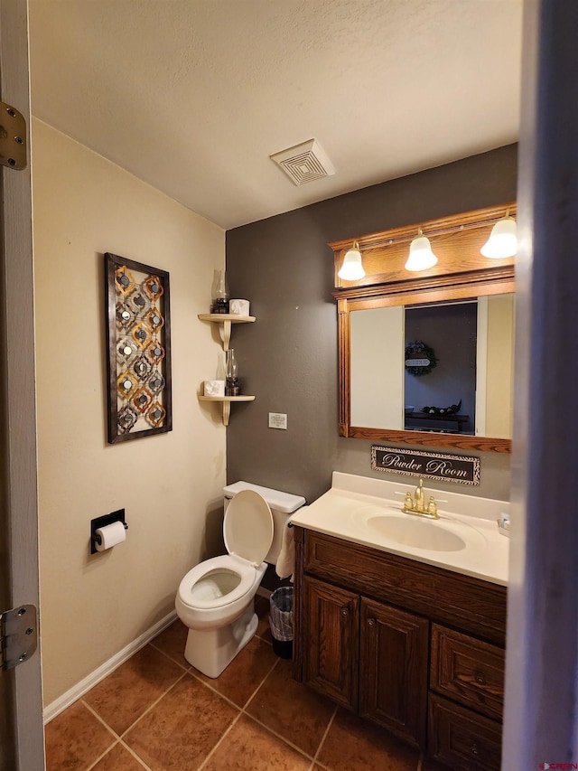 half bathroom featuring vanity, toilet, visible vents, and tile patterned floors