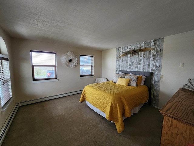 carpeted bedroom with a baseboard radiator, a textured ceiling, and baseboards