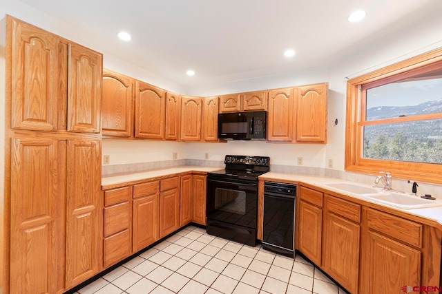 kitchen featuring a sink, light countertops, black appliances, and recessed lighting