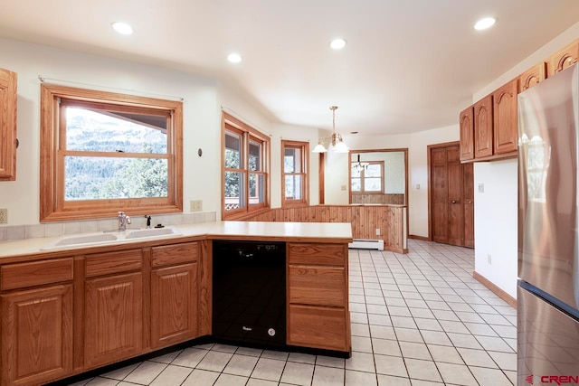 kitchen with a peninsula, a sink, freestanding refrigerator, black dishwasher, and light countertops