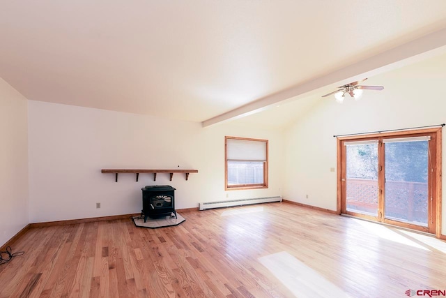 unfurnished living room featuring a ceiling fan, lofted ceiling with beams, a baseboard heating unit, a wood stove, and light wood-style floors