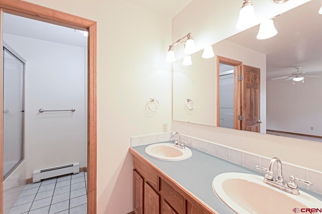 full bath featuring a ceiling fan, tile patterned flooring, baseboard heating, and a sink