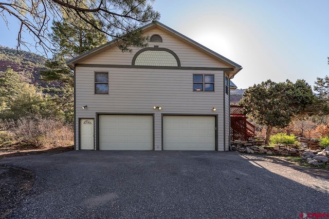 garage with aphalt driveway
