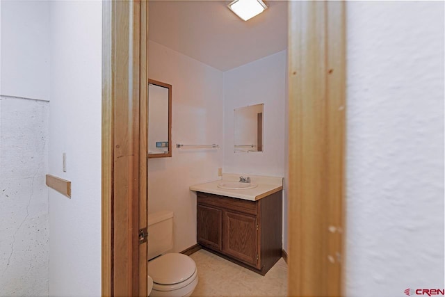 bathroom with toilet and vanity