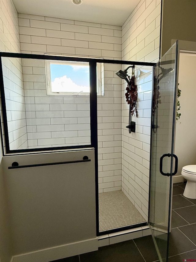 710 SE Pine St, Cedaredge, CO 81413 - full bathroom with tile patterned floors, a stall shower, baseboards, and toilet
