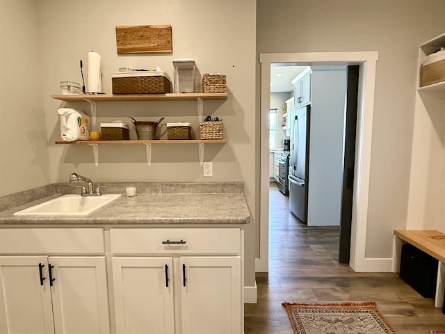 710 SE Pine St, Cedaredge, CO 81413 - bar with freestanding refrigerator, a sink, dark wood-style flooring, and baseboards