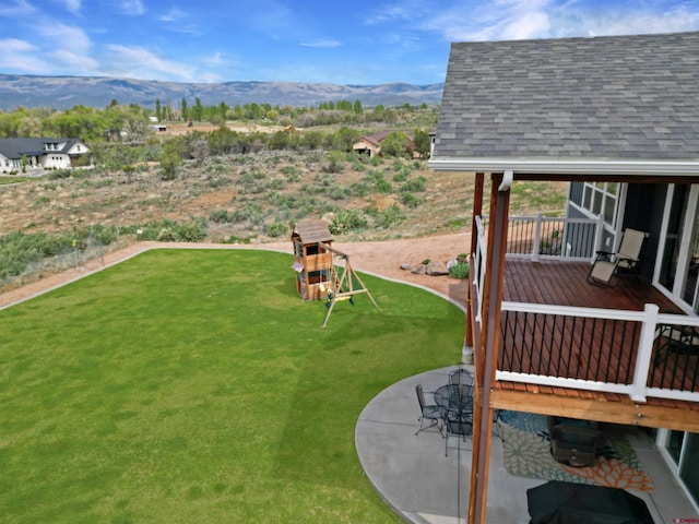 710 SE Pine St, Cedaredge, CO 81413 - view of green lawn with a mountain view and a patio