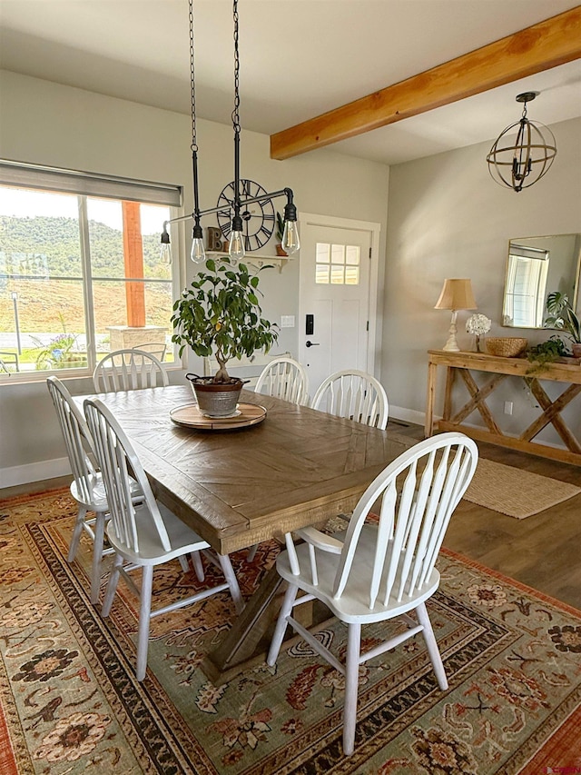 710 SE Pine St, Cedaredge, CO 81413 - dining space featuring a chandelier, baseboards, beam ceiling, and wood finished floors