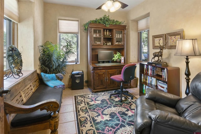 home office with light tile patterned flooring and a ceiling fan