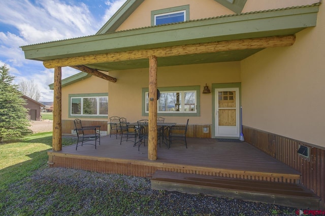 view of patio with a deck and outdoor dining space
