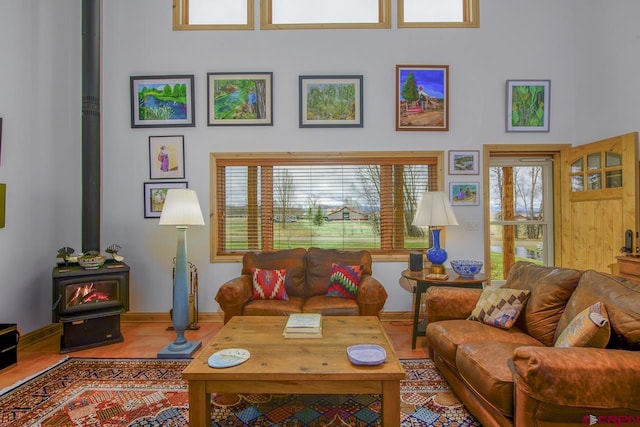 living room featuring a wood stove and baseboards