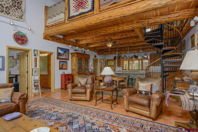 living area with beam ceiling, stairway, tile patterned flooring, baseboards, and wooden ceiling