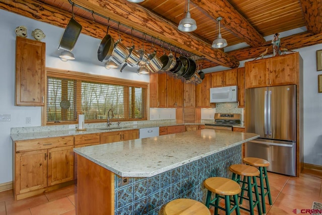 kitchen with stainless steel appliances, a sink, light tile patterned floors, wood ceiling, and a kitchen island