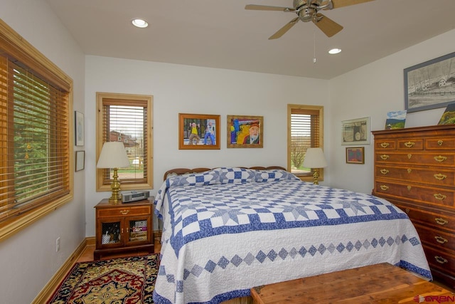 bedroom featuring wood finished floors, recessed lighting, a ceiling fan, and baseboards