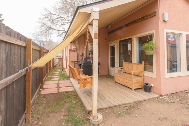 wooden deck featuring a fenced backyard