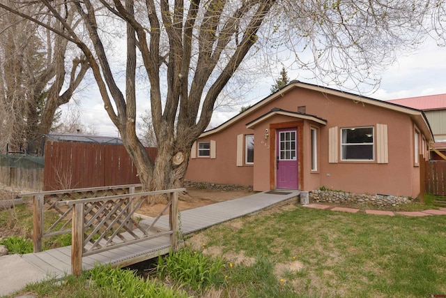 view of front of home with stucco siding and a wooden deck