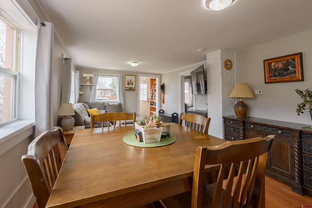 dining space with wood finished floors
