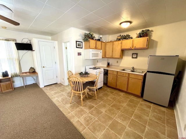kitchen featuring white appliances, a sink, and light countertops