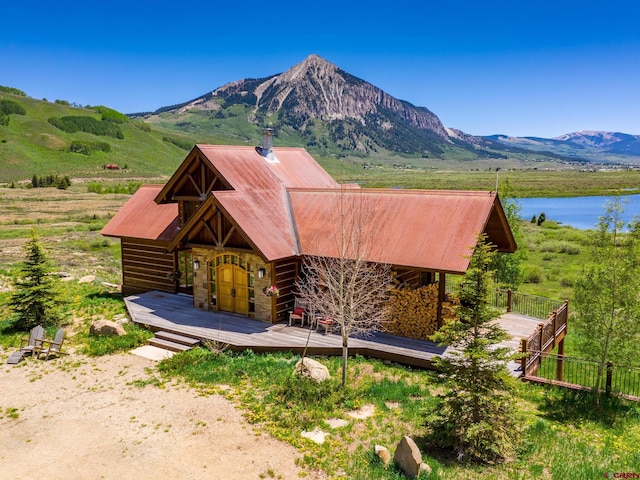 1482 Peanut Lake Rd, Crested Butte, CO 81224 - back of house with fence, a deck with water view, and metal roof