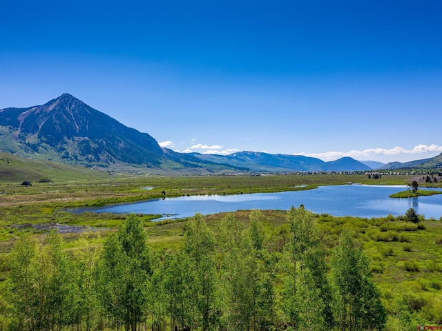 view of mountain background featuring a nearby body of water