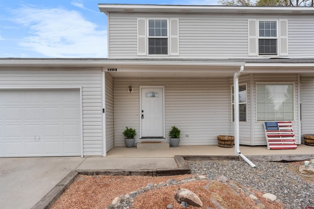 view of front facade with a porch, an attached garage, and concrete driveway