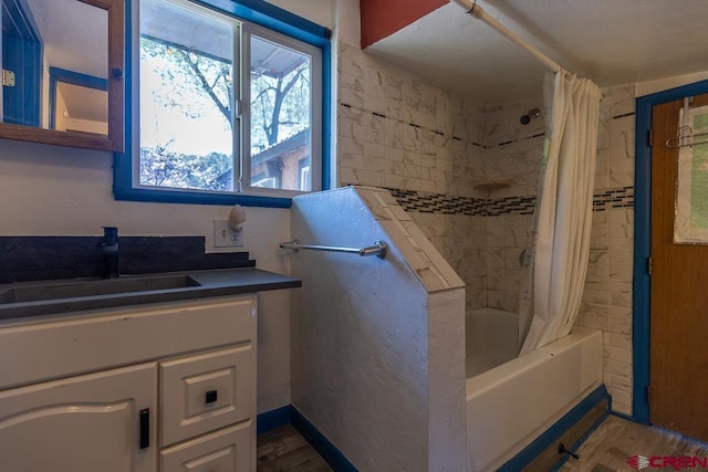 full bath with shower / bath combo, vanity, and wood finished floors