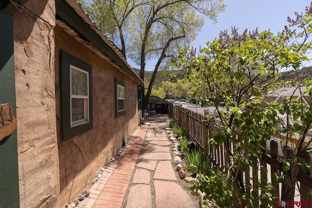 view of property exterior with a fenced backyard and stucco siding