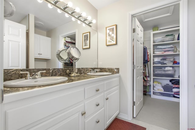 292 E Golf Pl Unit B, Pagosa Springs, CO 81147 - bathroom featuring a walk in closet and double vanity