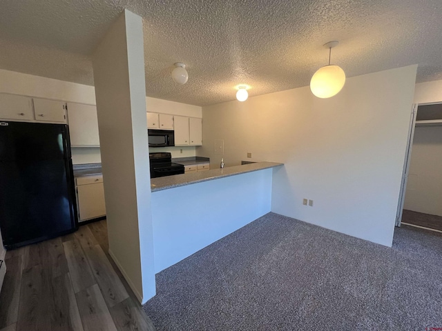 1135 Florida Rd, Durango, CO 81301 - kitchen with black appliances, white cabinets, a textured ceiling, hanging light fixtures, and a peninsula
