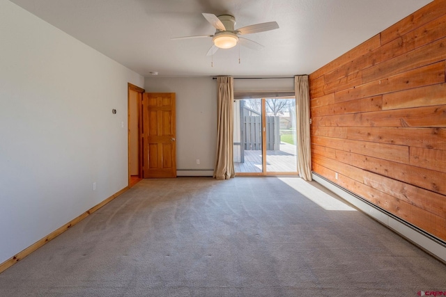 169 Camino Del Rio Unit 8, Gunnison, CO 81230 - empty room with baseboard heating, ceiling fan, carpet floors, baseboards, and wooden walls