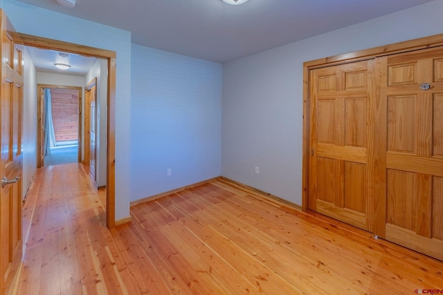 169 Camino Del Rio Unit 8, Gunnison, CO 81230 - unfurnished bedroom with light wood-type flooring, baseboards, and a closet
