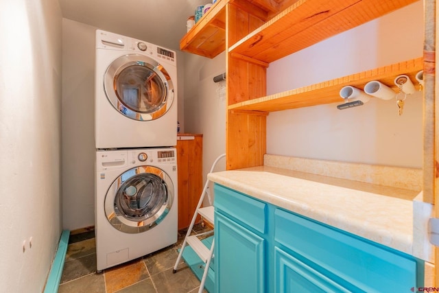 169 Camino Del Rio Unit 8, Gunnison, CO 81230 - laundry room featuring stacked washer / dryer and dark stone finish flooring