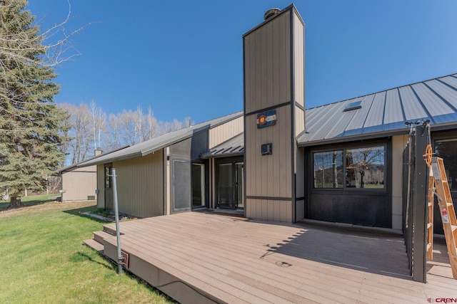 169 Camino Del Rio Unit 8, Gunnison, CO 81230 - rear view of house featuring a wooden deck, metal roof, a yard, and a chimney