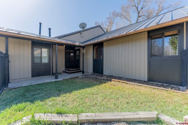 169 Camino Del Rio Unit 8, Gunnison, CO 81230 - entrance to property with metal roof, a yard, and a standing seam roof