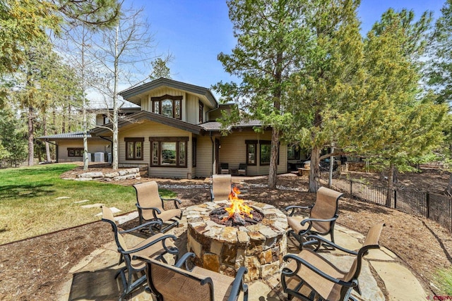 rear view of house with an outdoor fire pit and a patio area