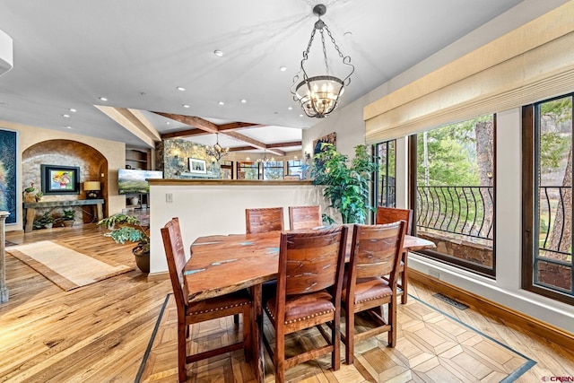 dining space with a chandelier, recessed lighting, light wood-type flooring, baseboards, and beamed ceiling