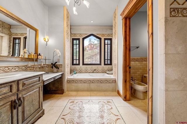 full bath featuring vanity, a garden tub, a bidet, and tile patterned flooring