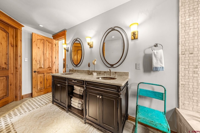 bathroom featuring double vanity, recessed lighting, and baseboards