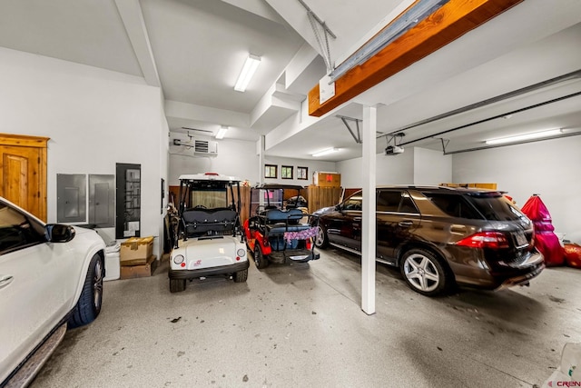 garage with a garage door opener and electric panel