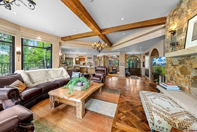 living area featuring beamed ceiling, a chandelier, a fireplace, and recessed lighting