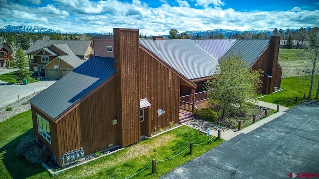 301 Talisman Dr Unit 4319, Pagosa Springs, CO 81147 - view of side of property featuring a chimney, metal roof, and a standing seam roof