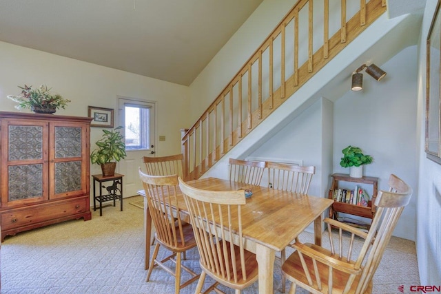 301 Talisman Dr Unit 4319, Pagosa Springs, CO 81147 - dining area featuring light carpet, lofted ceiling, and stairway
